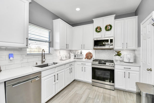 kitchen with sink, stainless steel appliances, and white cabinets