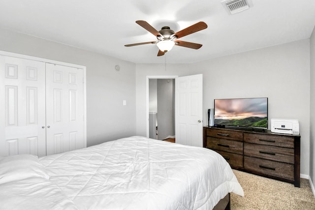 carpeted bedroom with a closet and ceiling fan