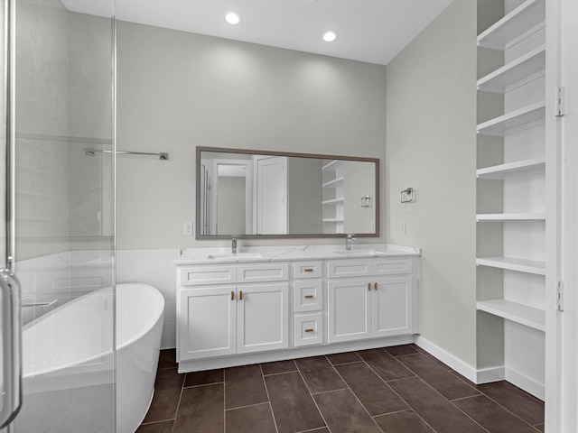 bathroom with vanity, tile patterned flooring, and a tub