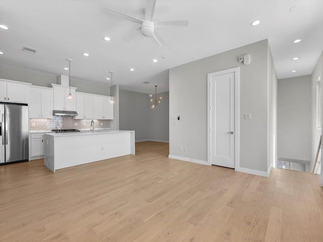 kitchen featuring a kitchen island with sink, hanging light fixtures, light hardwood / wood-style floors, white cabinets, and stainless steel fridge with ice dispenser