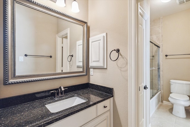 full bathroom with tile patterned floors, vanity, toilet, and combined bath / shower with glass door