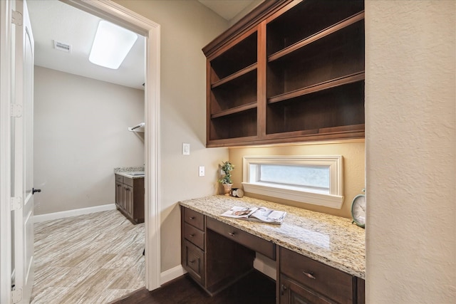 office space with hardwood / wood-style flooring and built in desk