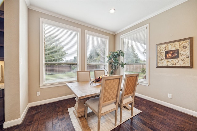 dining area with crown molding and dark wood-type flooring