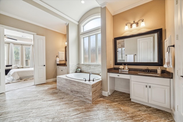 bathroom featuring vanity, crown molding, and tiled bath