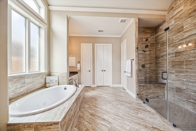 bathroom featuring vanity, ornamental molding, and separate shower and tub