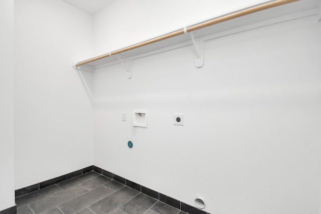 laundry area featuring dark tile patterned flooring, hookup for a washing machine, and electric dryer hookup