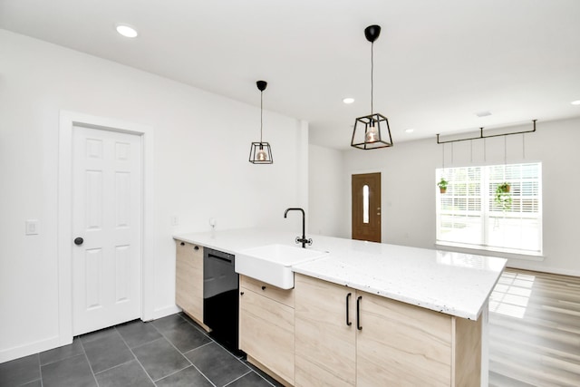 kitchen featuring sink, black dishwasher, decorative light fixtures, kitchen peninsula, and light brown cabinets