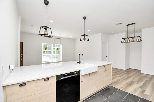 kitchen featuring sink, hanging light fixtures, black dishwasher, and light brown cabinets