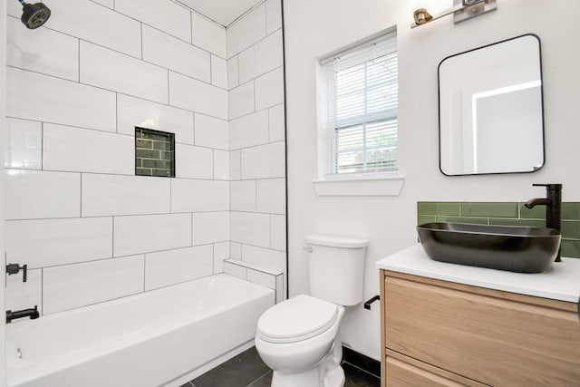 full bathroom with vanity, tiled shower / bath, and toilet