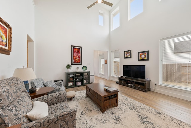 living room featuring ceiling fan and light wood-type flooring