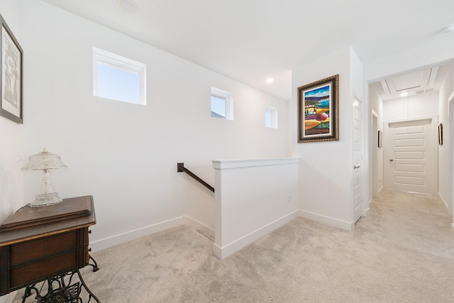 hall featuring light colored carpet