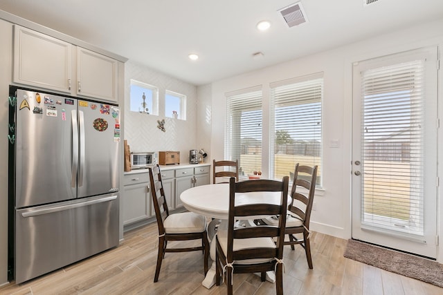 dining area with light hardwood / wood-style floors