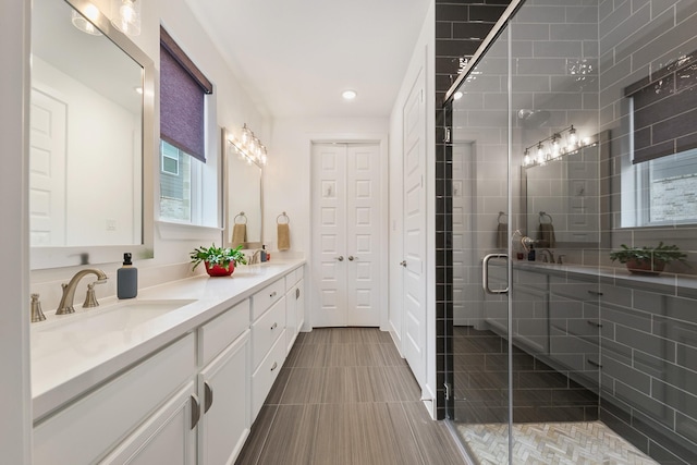 bathroom featuring walk in shower, vanity, and tile patterned flooring