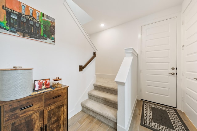 stairs featuring hardwood / wood-style flooring