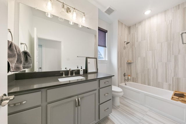 full bathroom with vanity, toilet, and tiled shower / bath