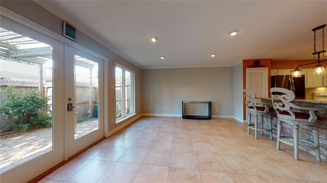 interior space featuring light tile patterned flooring and crown molding