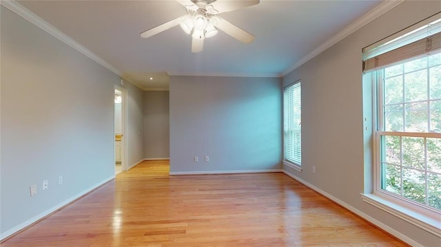 empty room with ornamental molding, light hardwood / wood-style floors, and ceiling fan