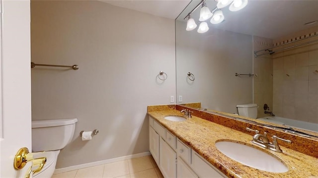 full bathroom featuring vanity, tiled shower / bath combo, tile patterned floors, and toilet