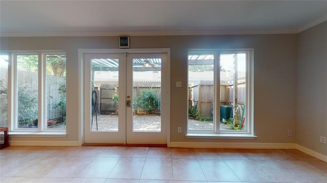 doorway featuring crown molding, french doors, a healthy amount of sunlight, and light tile patterned flooring