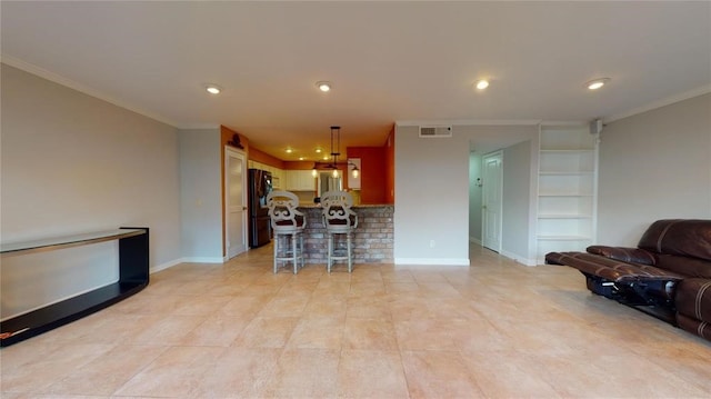 living room featuring crown molding and built in features