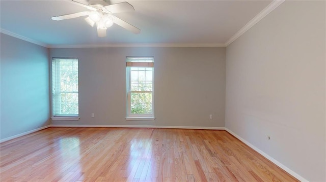 unfurnished room with light hardwood / wood-style flooring, ornamental molding, and a healthy amount of sunlight