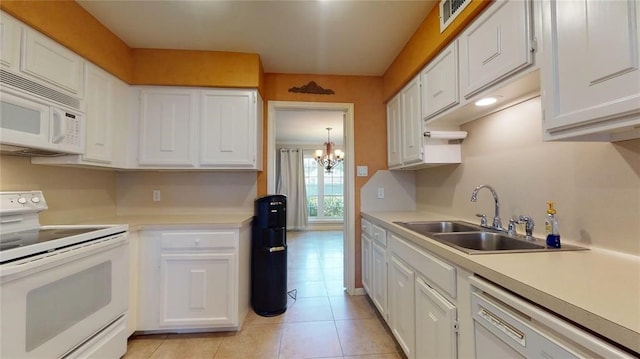 kitchen featuring white cabinetry, sink, white appliances, and light tile patterned floors