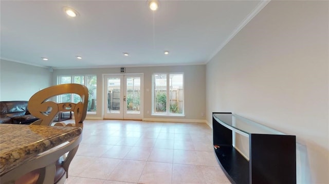 interior space with crown molding, light tile patterned flooring, and french doors