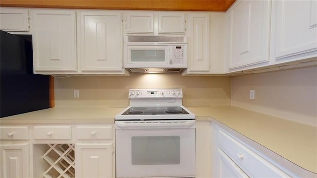 kitchen with white cabinetry and white appliances