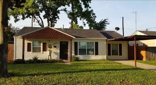 ranch-style home featuring a front yard