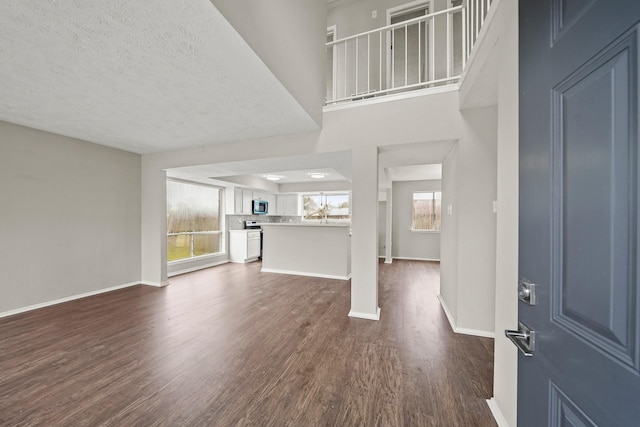 entryway with dark hardwood / wood-style flooring and a textured ceiling