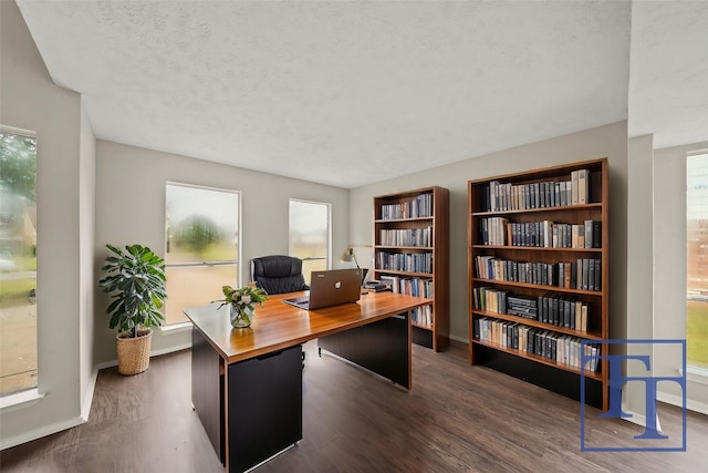 office featuring dark wood-type flooring and a textured ceiling