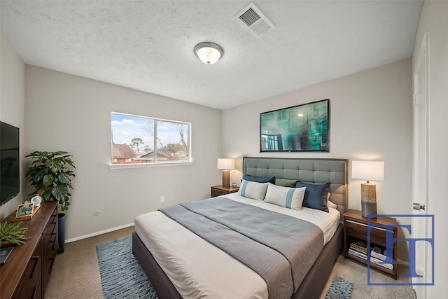 bedroom with carpet flooring and a textured ceiling