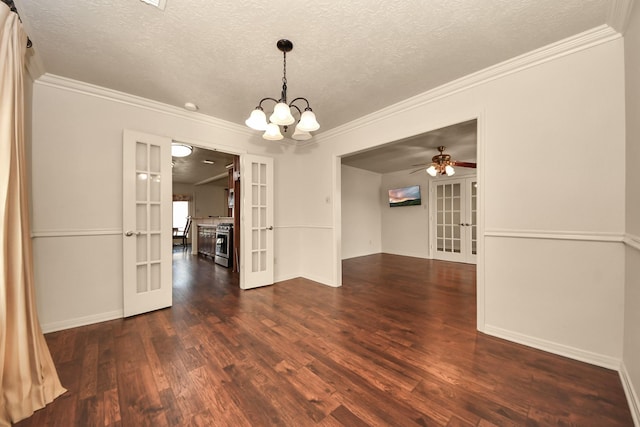 spare room with ceiling fan with notable chandelier, ornamental molding, dark wood-type flooring, a textured ceiling, and french doors