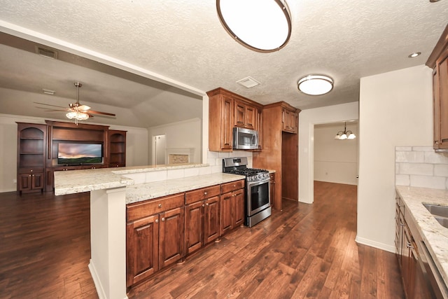 kitchen featuring tasteful backsplash, appliances with stainless steel finishes, dark hardwood / wood-style flooring, kitchen peninsula, and a kitchen breakfast bar