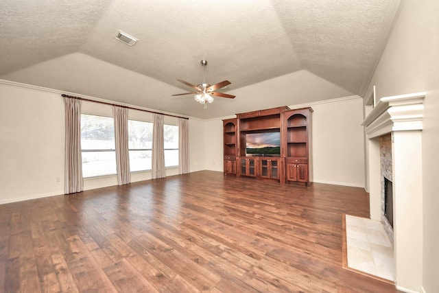 unfurnished living room featuring lofted ceiling, hardwood / wood-style floors, a textured ceiling, and ceiling fan