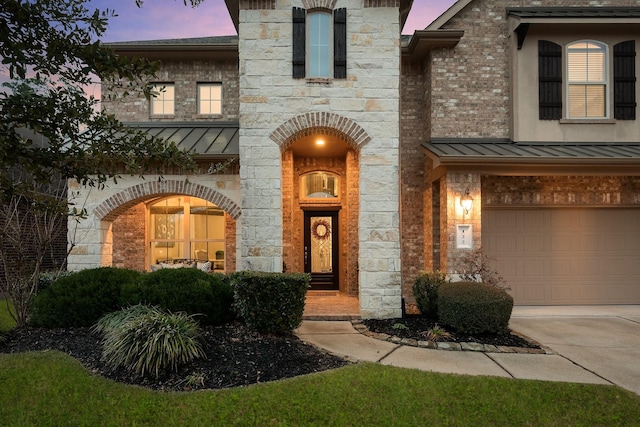 exterior entry at dusk with a garage