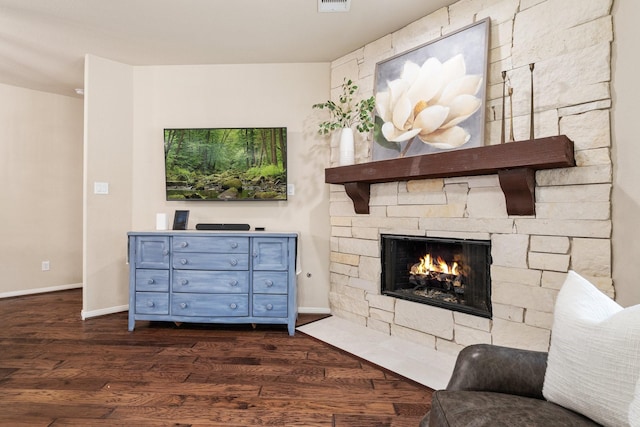 living room with a fireplace and dark hardwood / wood-style flooring