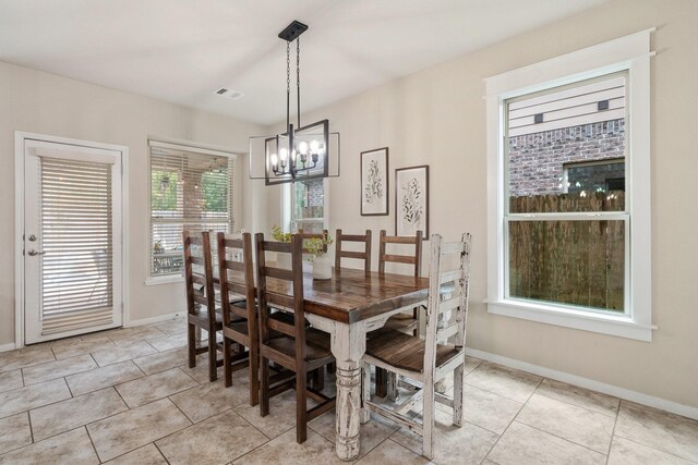 tiled dining space with a notable chandelier