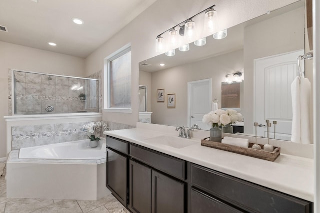 bathroom with vanity, tile patterned flooring, and plus walk in shower