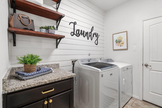 washroom with washer and clothes dryer and light tile patterned floors