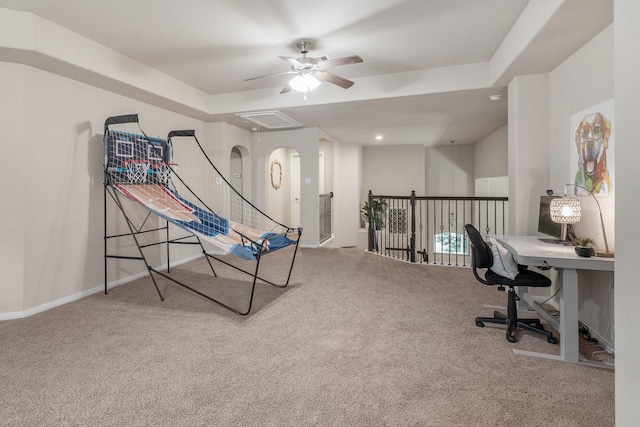 rec room with carpet, ceiling fan, and a tray ceiling