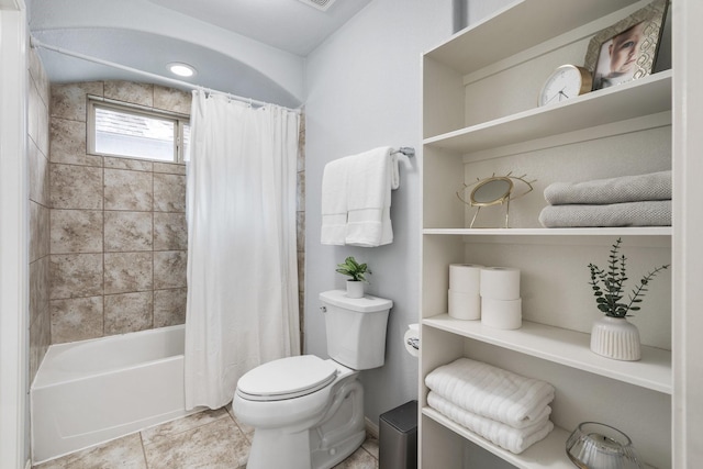 bathroom with tile patterned flooring, shower / tub combo, and toilet