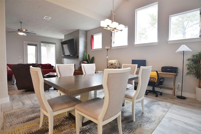 dining space featuring light wood-type flooring, plenty of natural light, a chandelier, and baseboards