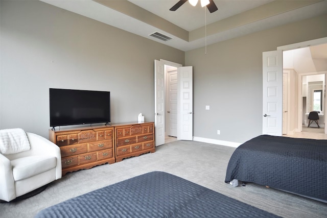 bedroom with carpet floors, a raised ceiling, visible vents, ceiling fan, and baseboards