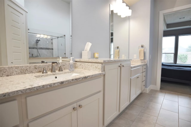 full bath with a shower stall, tile patterned flooring, and vanity