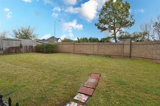 view of yard featuring a fenced backyard