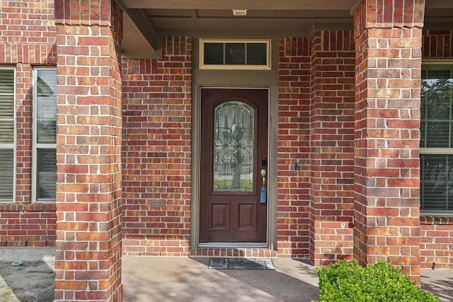 property entrance with brick siding