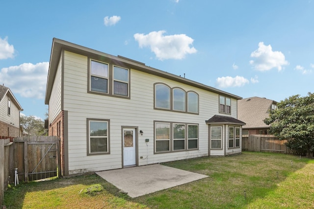 back of property featuring a yard, a fenced backyard, a gate, and a patio