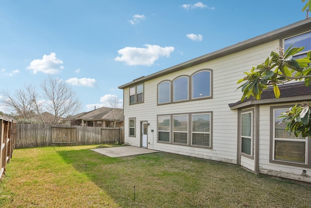 back of property with a patio, a yard, and a fenced backyard