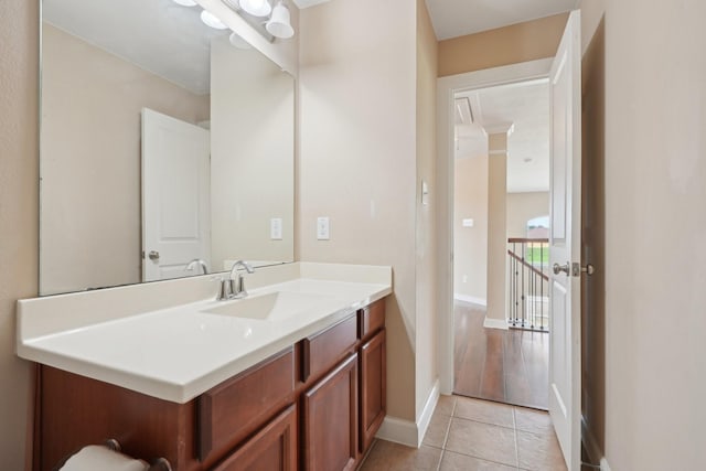 bathroom with tile patterned flooring, vanity, and baseboards